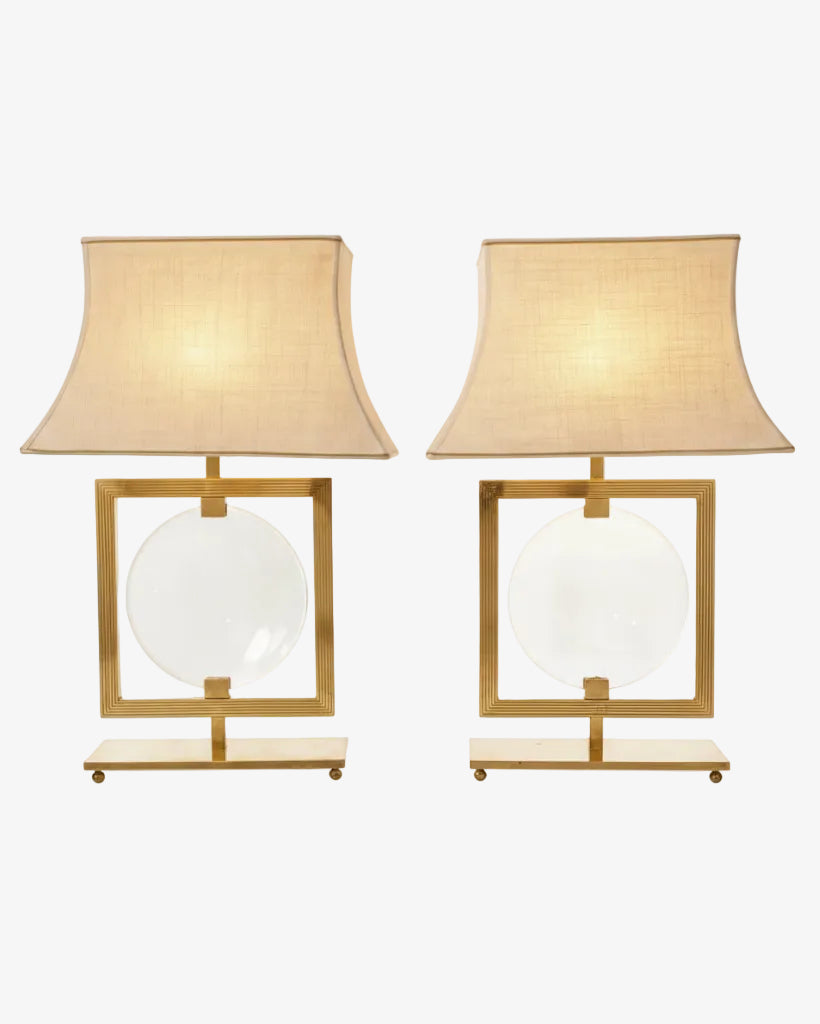 Pair of brass lamps with central lens