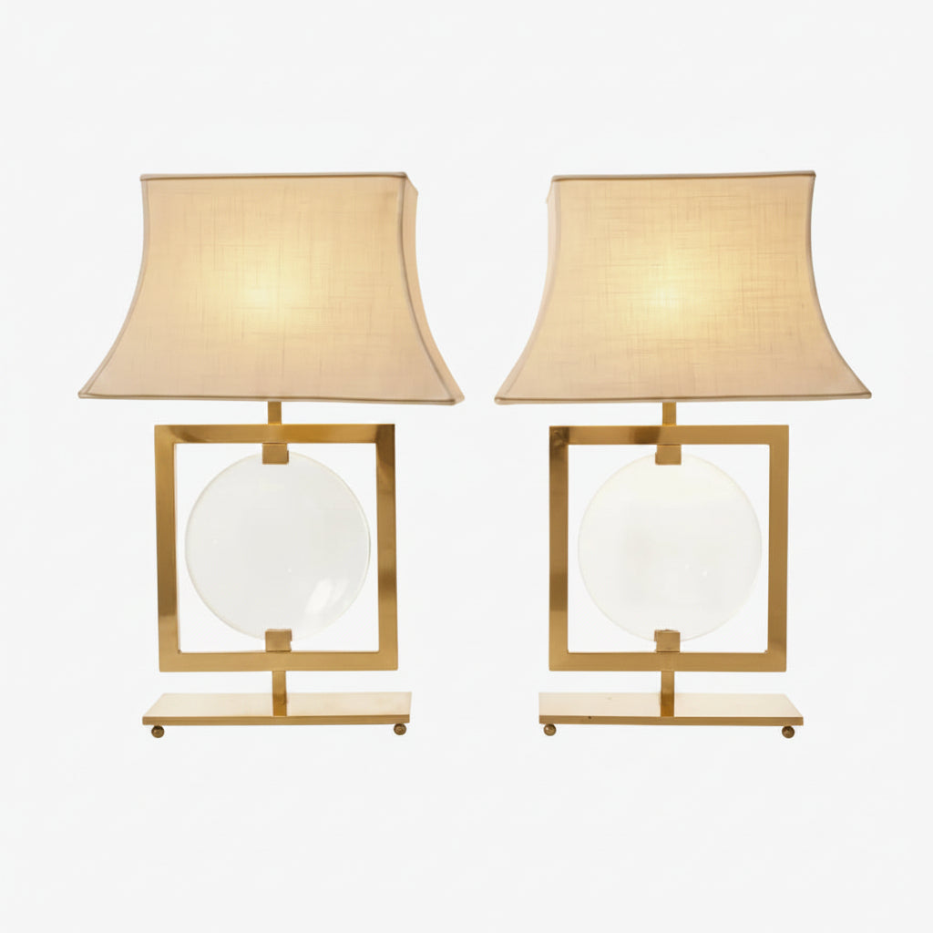 Pair of brass lamps with central lens