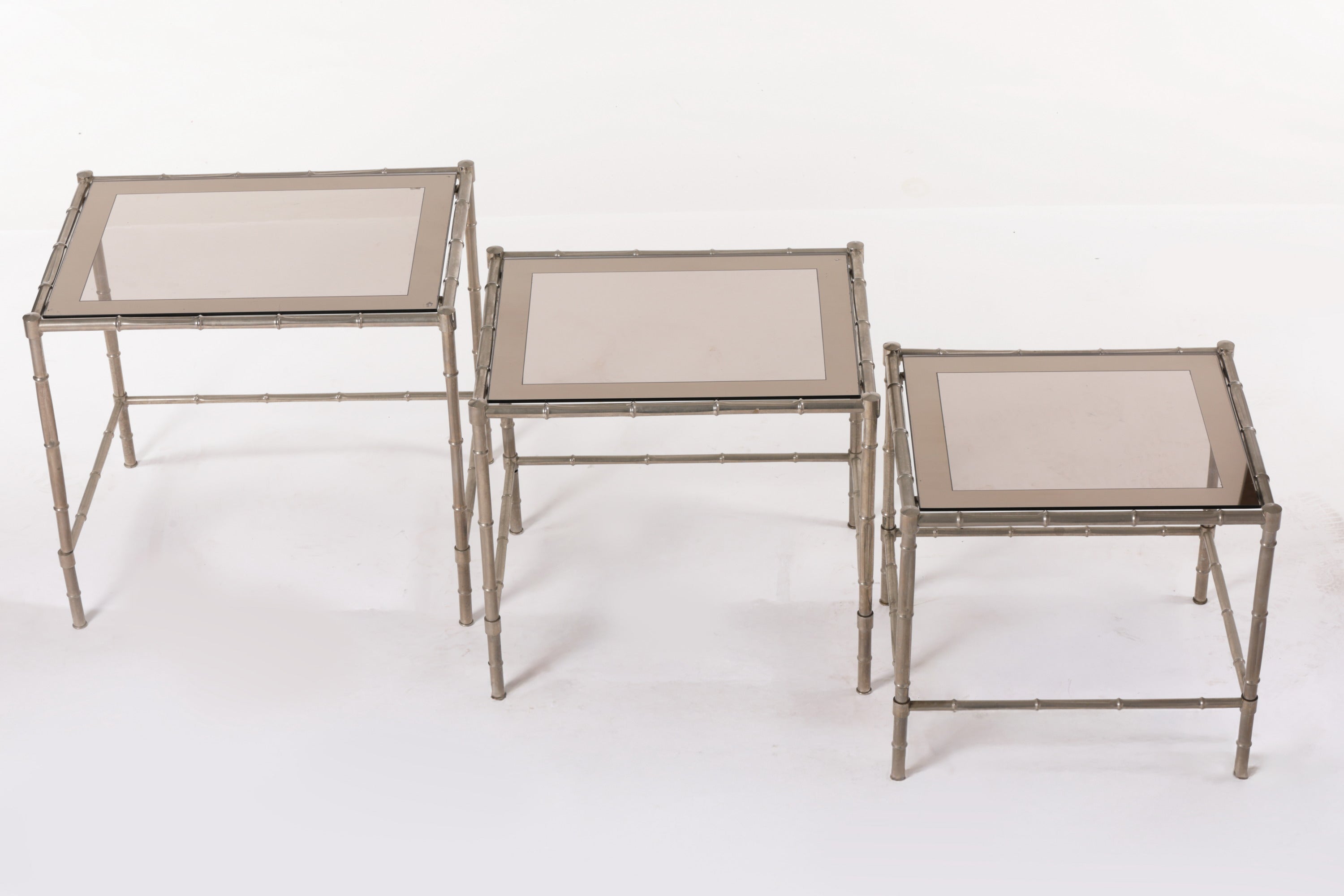 Triptych of silver bamboo tables from the 70s