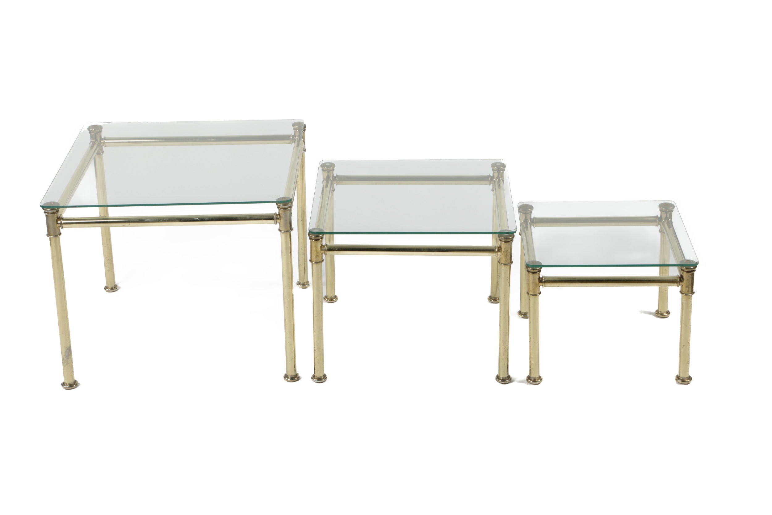 Triptych of brass and smoked glass tables from the 70s