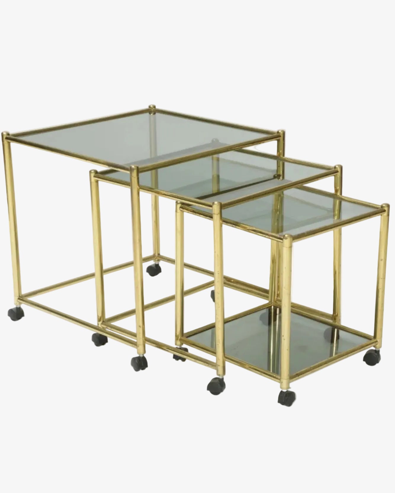 Triptych of brass and smoked glass tables from the 70s