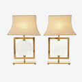 Pair of brass lamps with central lens