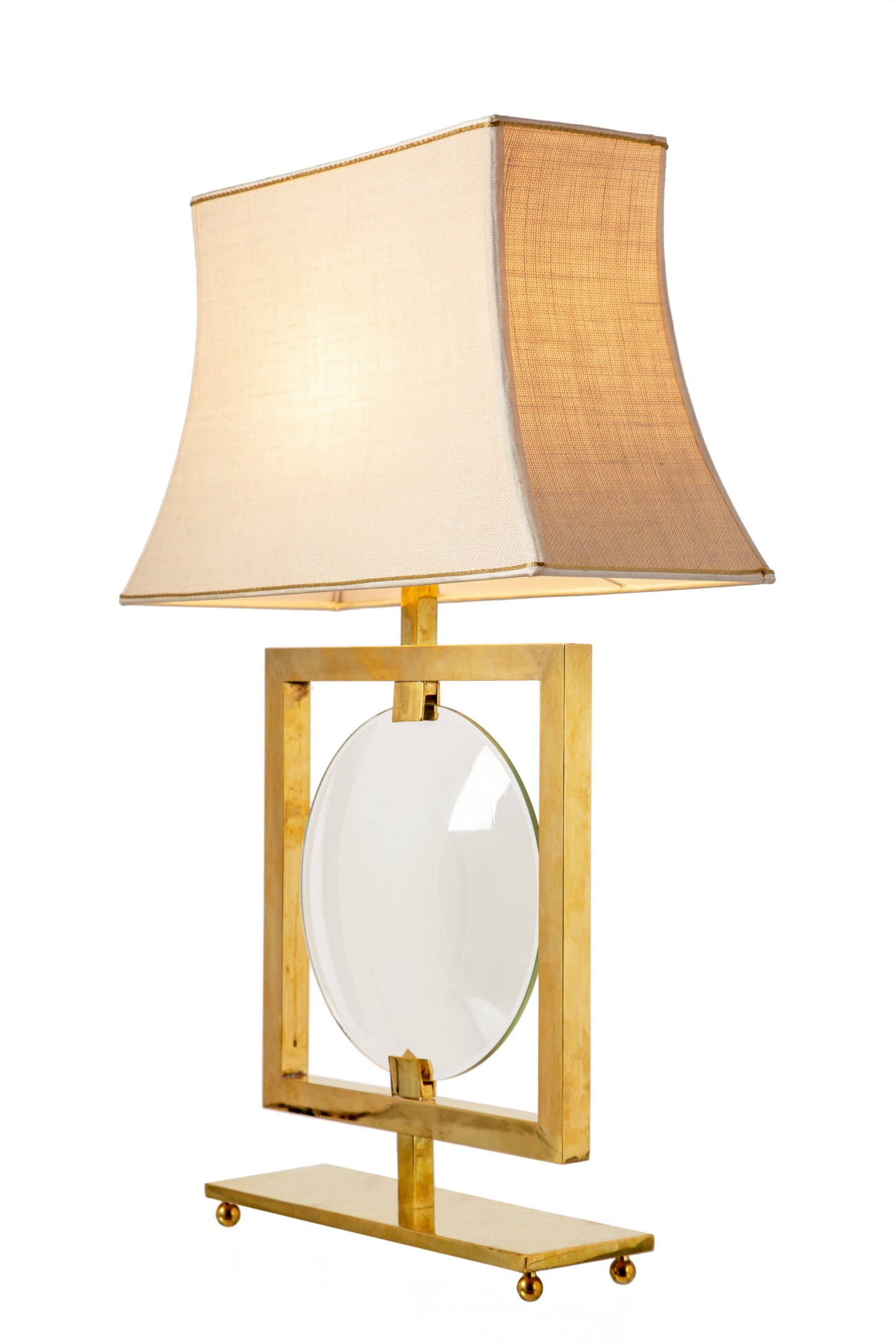 Pair of brass lamps with central lens