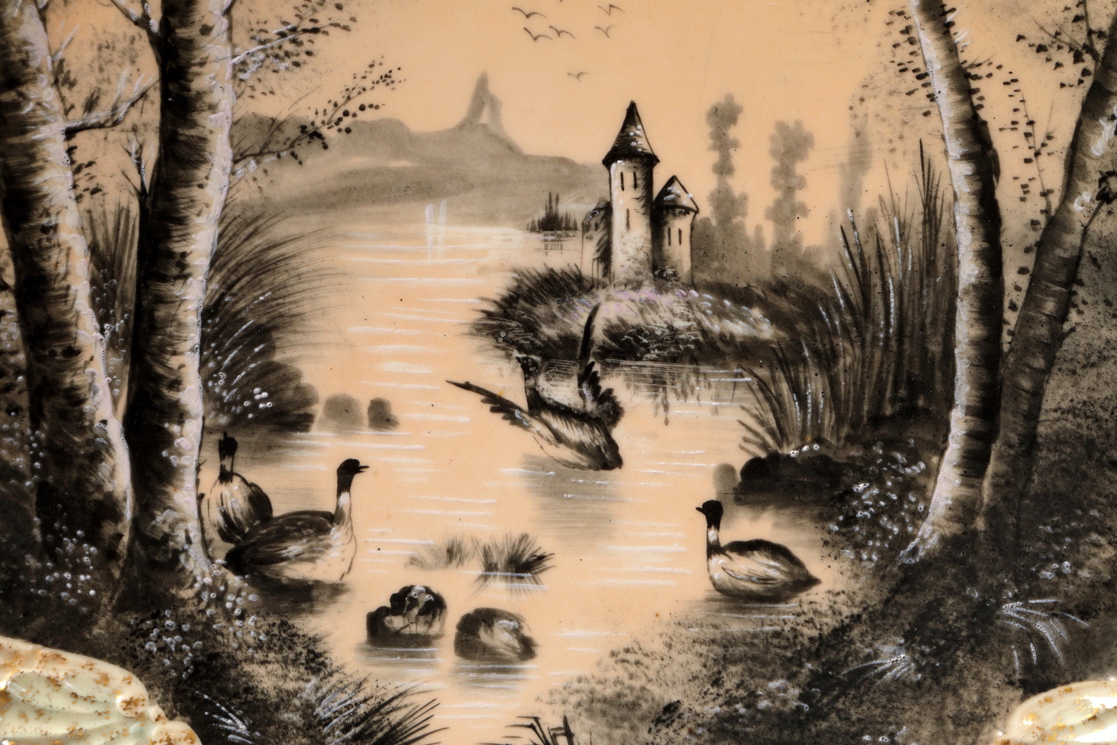 Pair of porcelain plates with lake scene and powder pink background