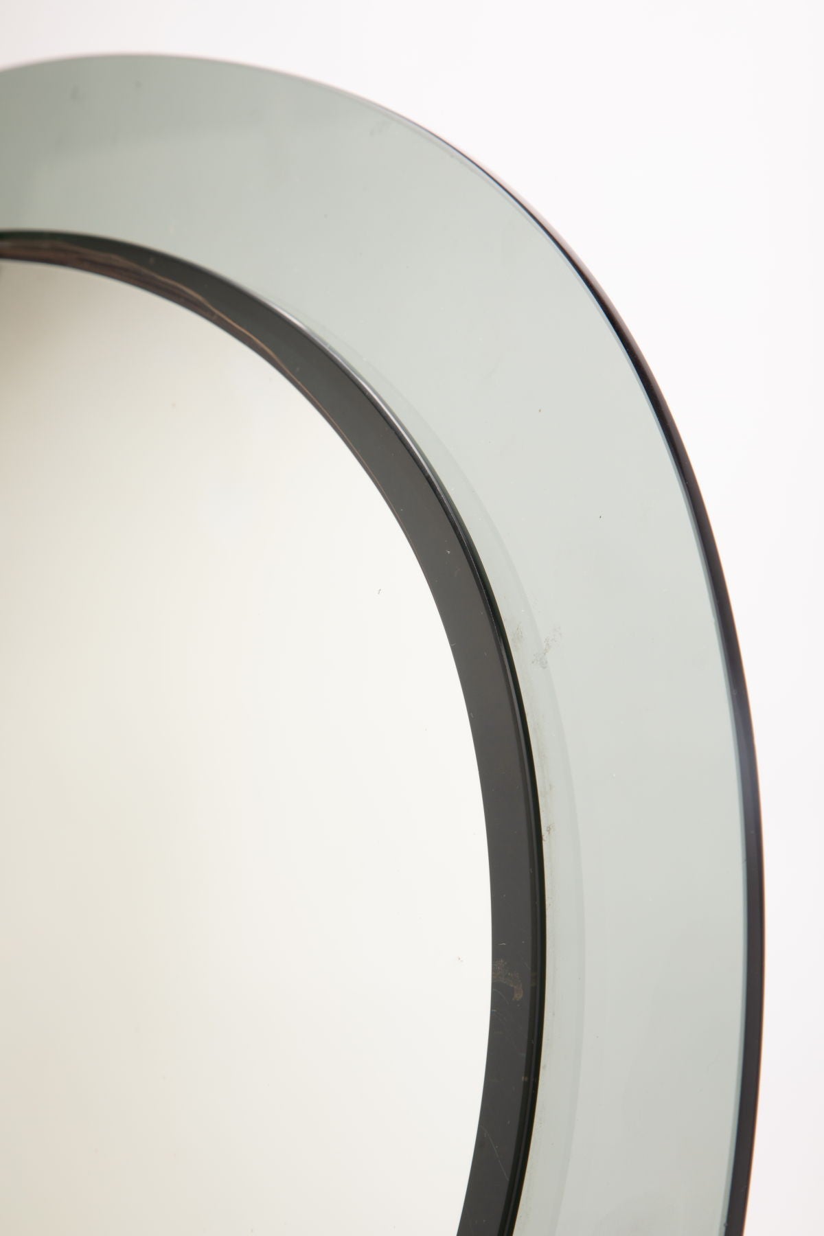 Smoked edge oval mirror from the 70s