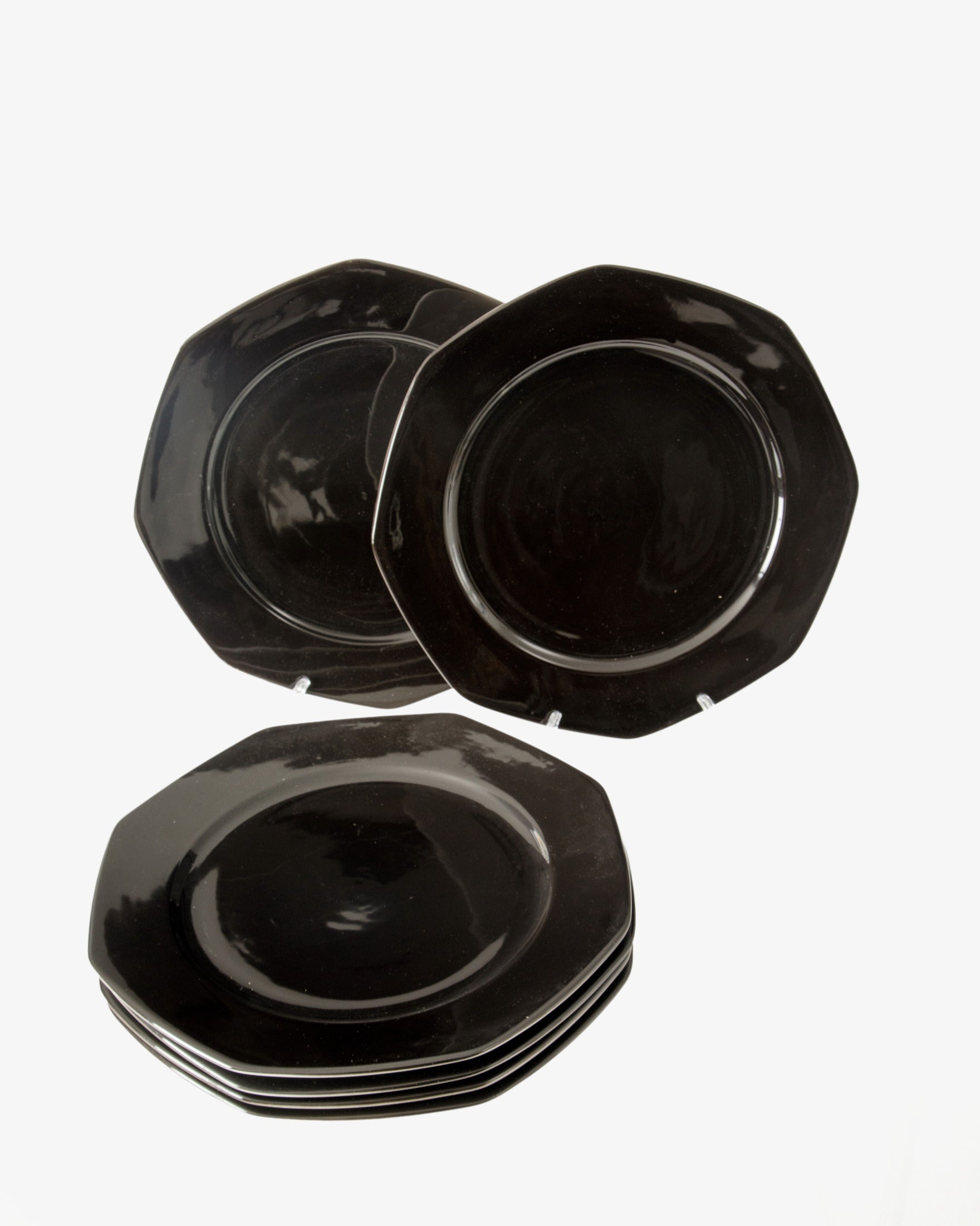 Six black octagonal placemats