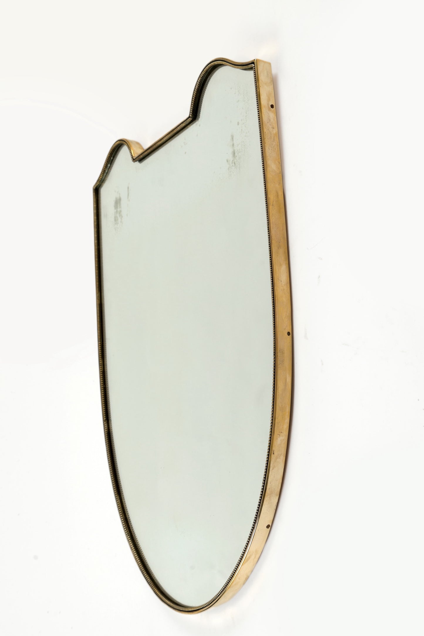 Brass shield mirror with worked edge, 1950s