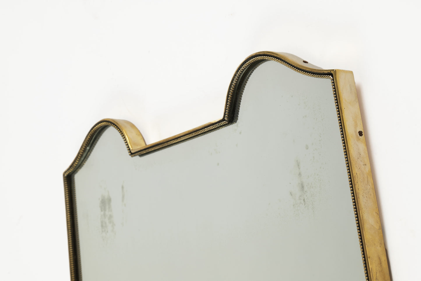 Brass shield mirror with worked edge, 1950s