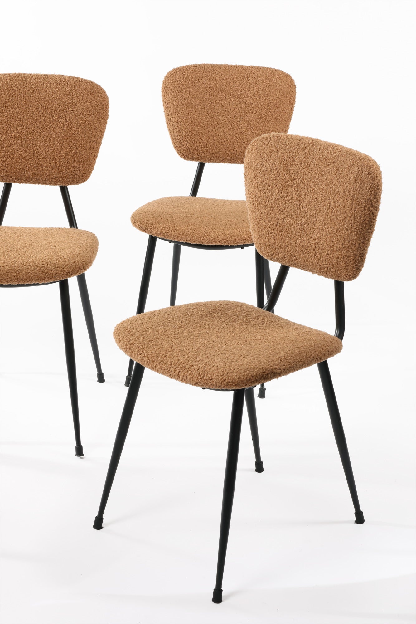 Four camel bouclé chairs from the 60s