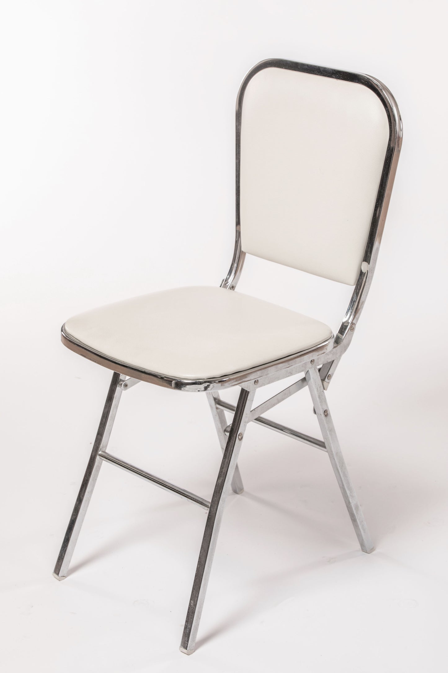 Four white leather folding chairs from the 70s