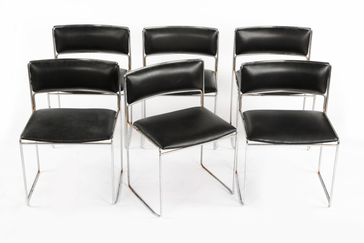 Six black leather chairs