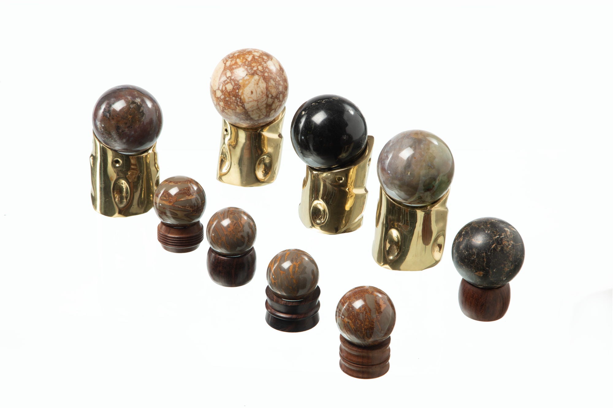 Set of ornaments in dark stone spheres with wooden and brass base