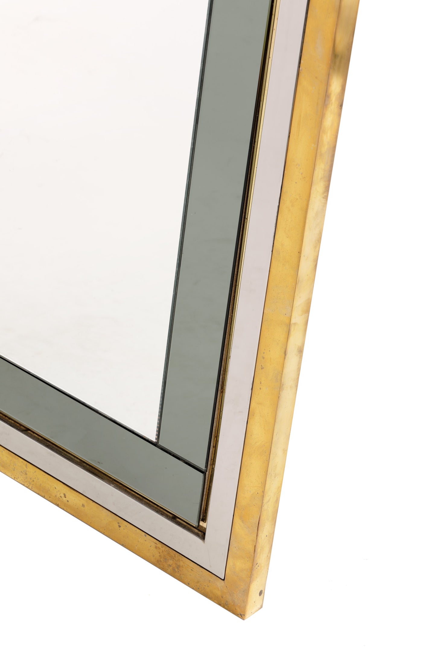 Mirror from the 70s in steel and brass with applied glass profiles