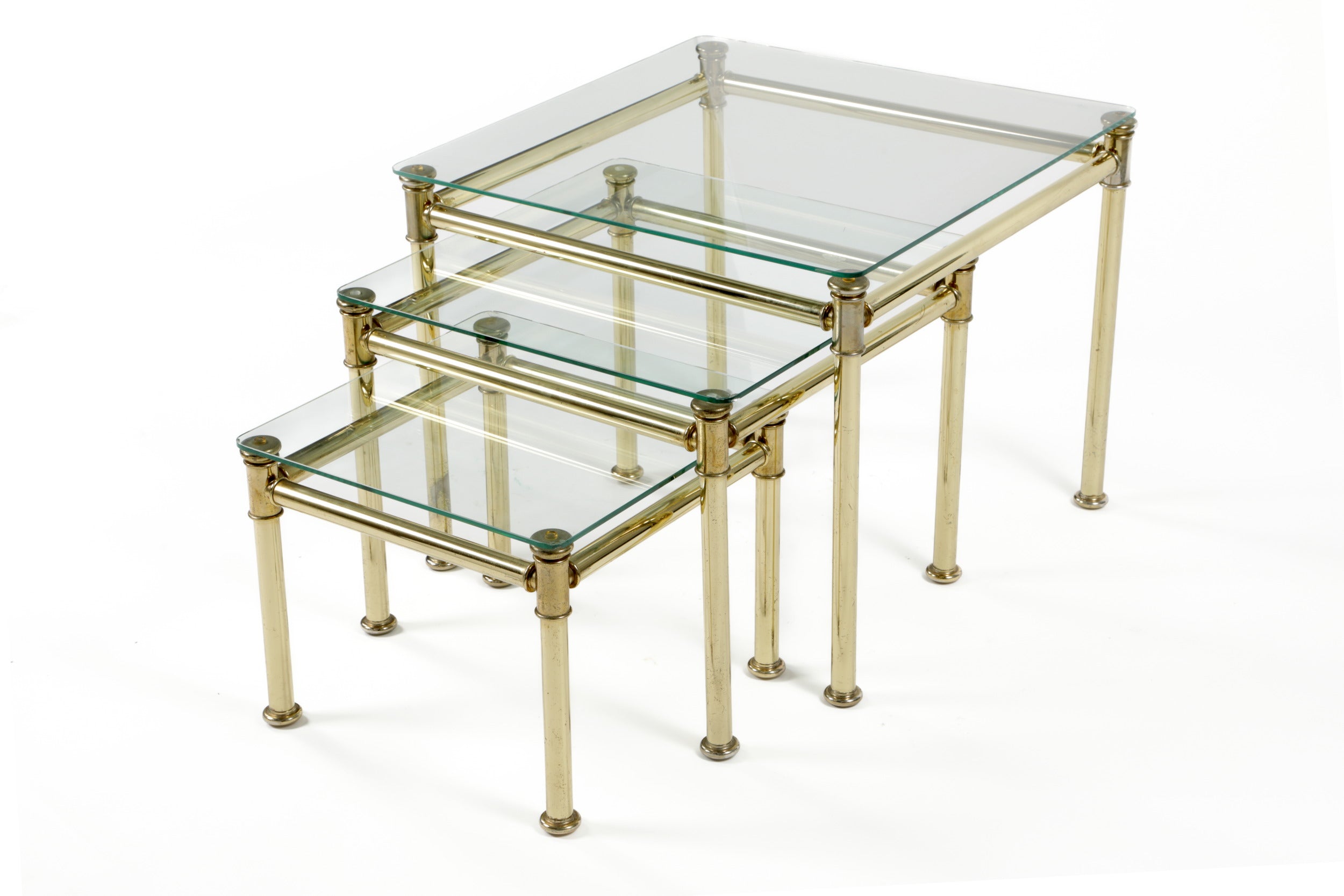 Triptych of brass and smoked glass tables from the 70s