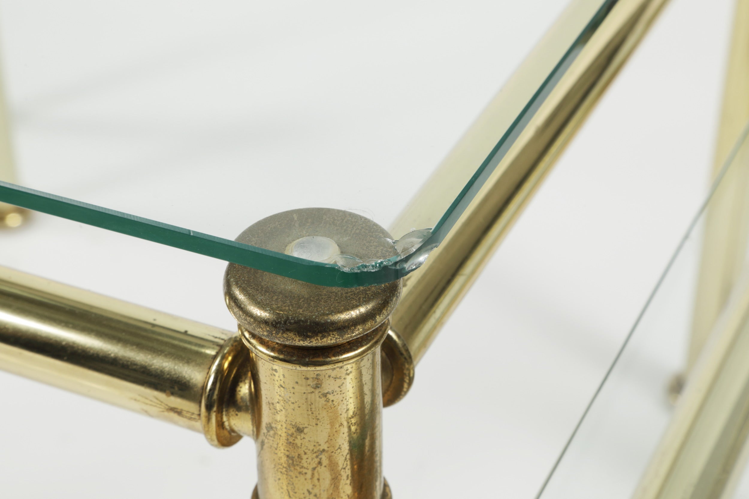 Triptych of brass and smoked glass tables from the 70s