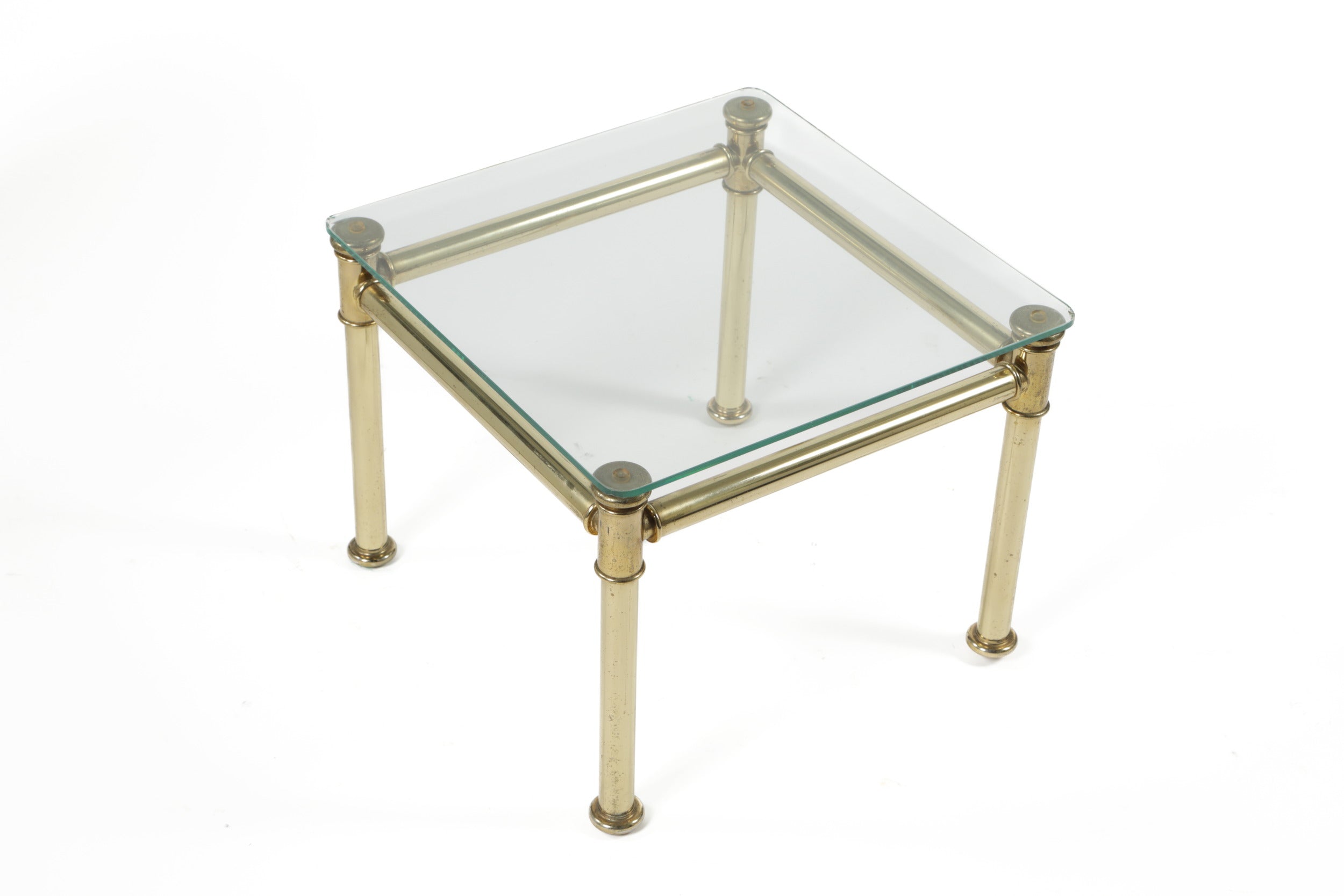 Triptych of brass and smoked glass tables from the 70s